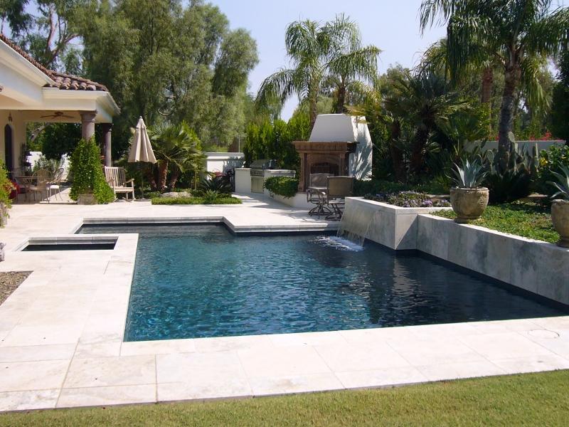 Custom landscaping project with water feature and garden beds